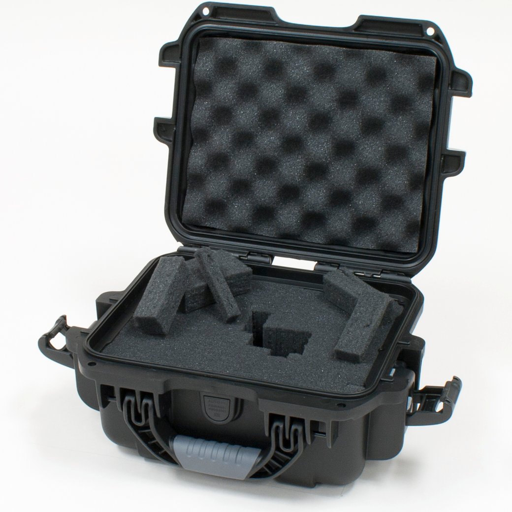 Black waterproof injection molded case with interior dimensions of 9.4" x 7.4" x 5.5" . DICED FOAM